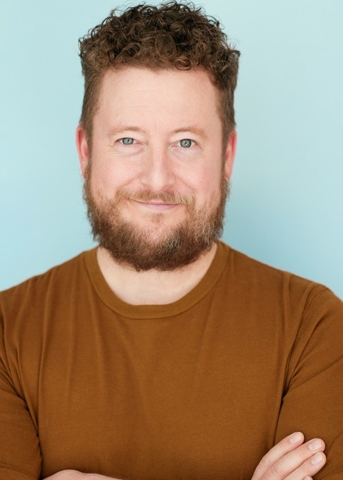 Lance Allen Kramer smiling with his arms crossed